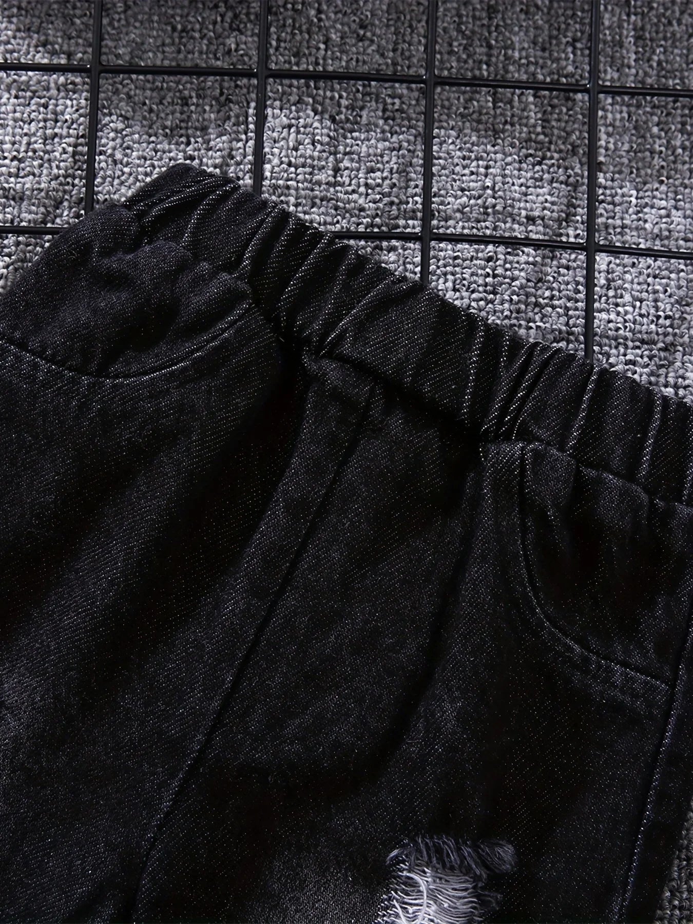 Back view of boys tartan polo shirt & denim trousers set