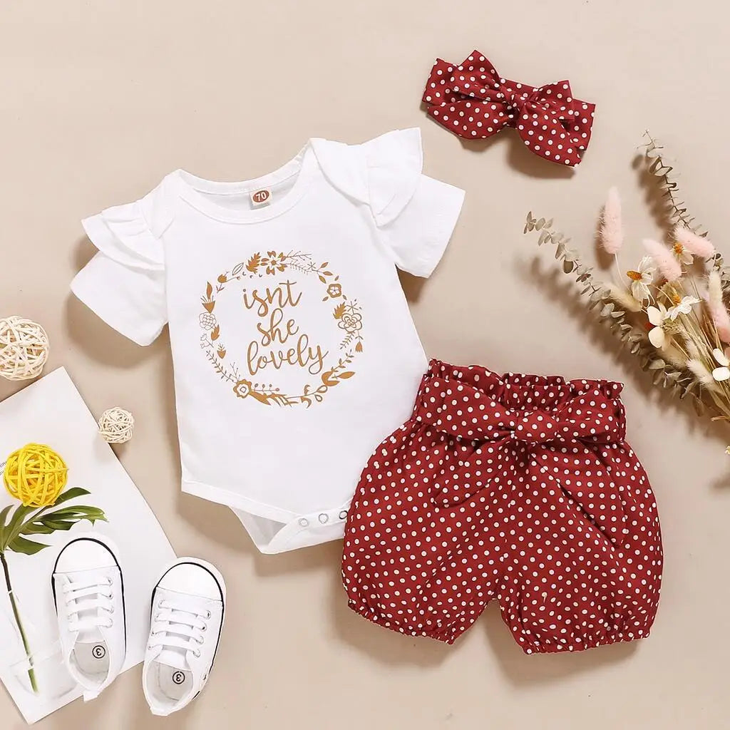 Close up detail of baby girls romper & polka dot trousers set