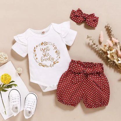 Close up detail of baby girls romper & polka dot trousers set