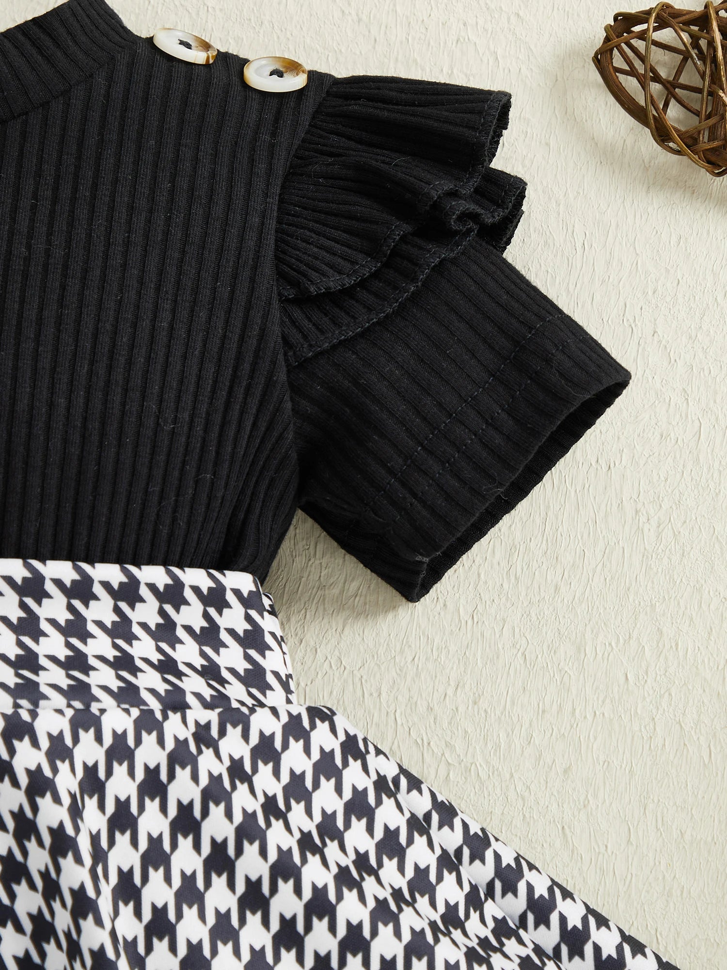 Close up detail of baby girls houndstooth romper dress set