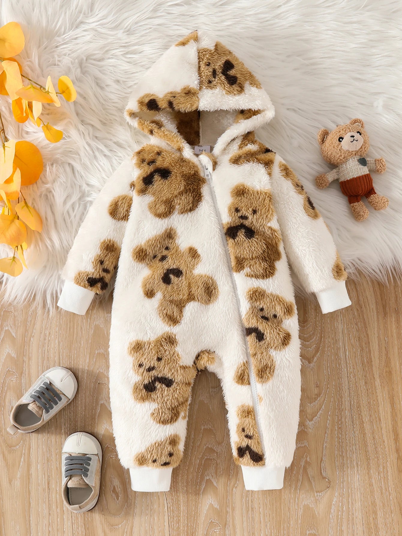 Baby girls fluffy long-sleeve onesie featuring an all-over teddy bear print
