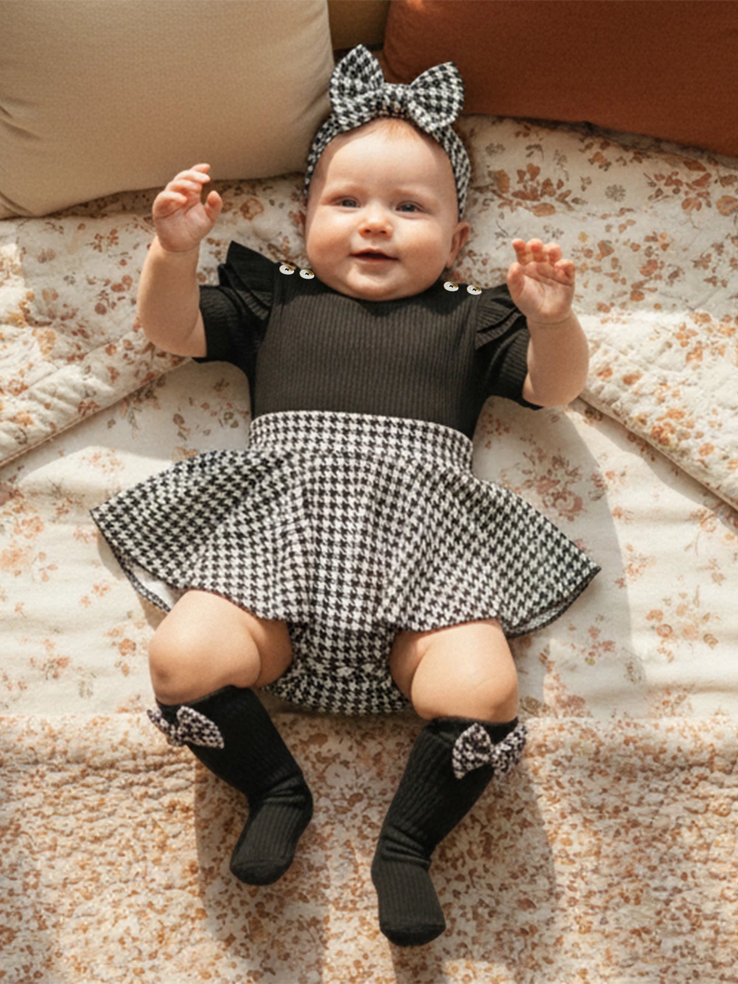 Fabric and texture detail of baby girls houndstooth romper dress set