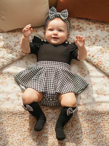 Fabric and texture detail of baby girls houndstooth romper dress set
