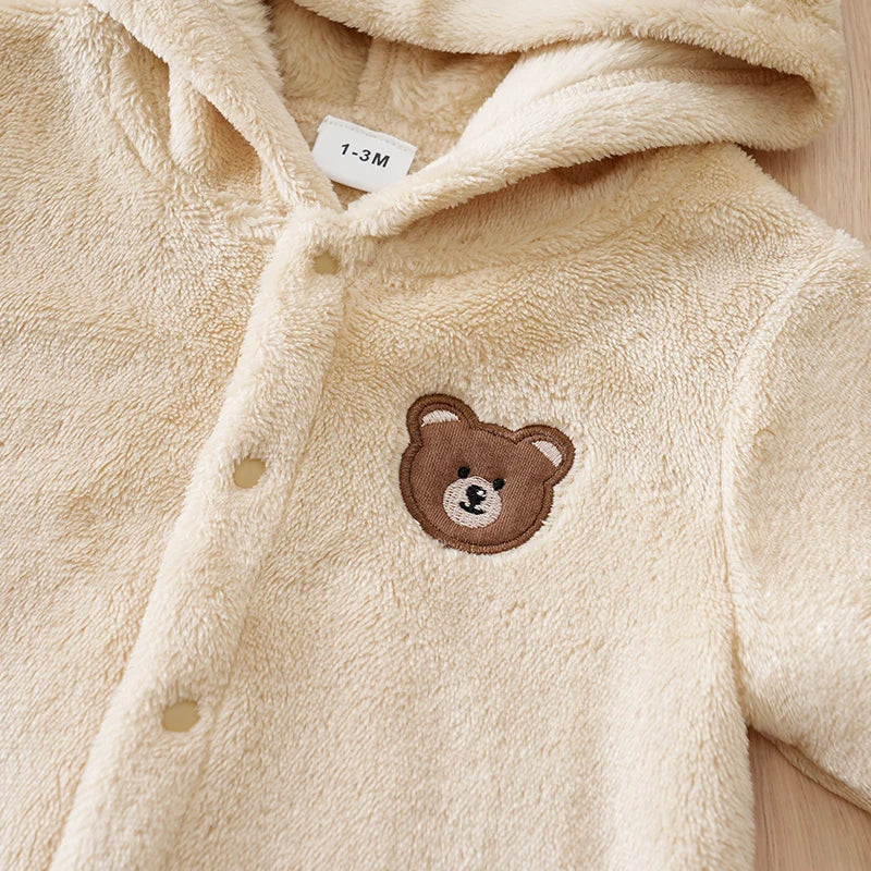 Close up detail of baby bear hooded winter flannel romper