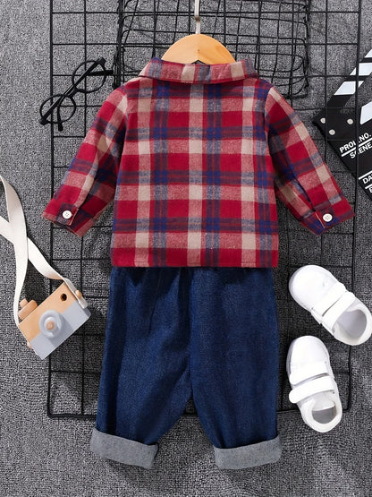 Side view of boys tartan polo shirt & denim trousers set
