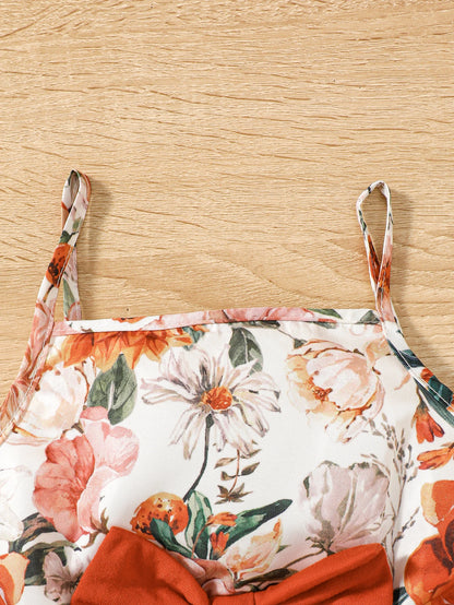 Girl wearing a puff sleeve top and a floral skirt with suspender straps
