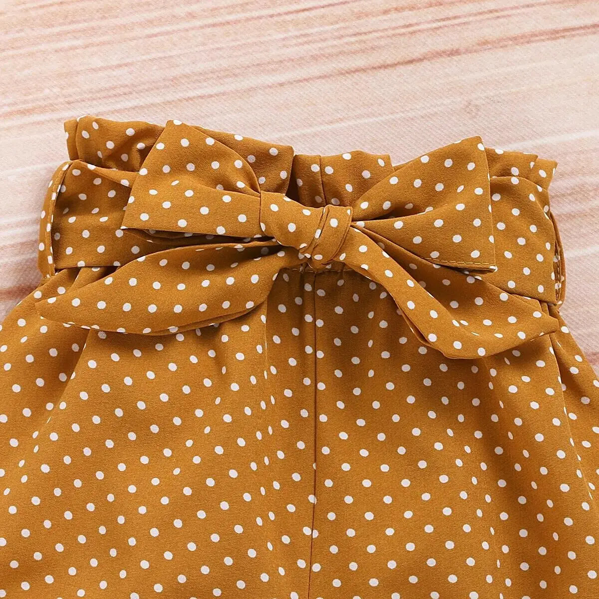 Back view of baby girls romper & polka dot trousers set
