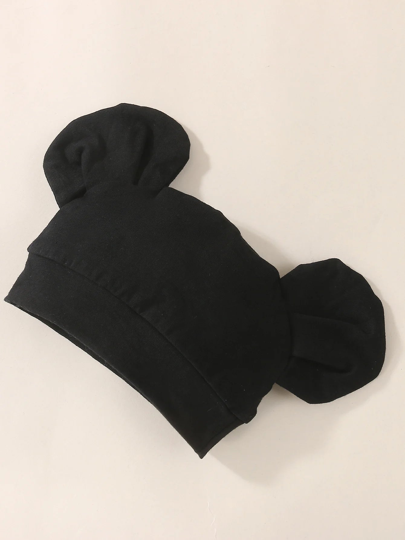 Close-up material detail of baby boys hello jumpsuit and hat set