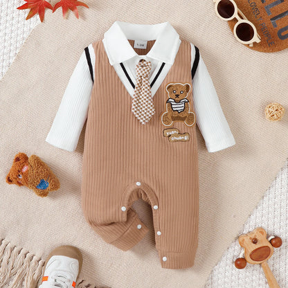 Baby boy wearing a smart short-sleeve romper with an attached tie