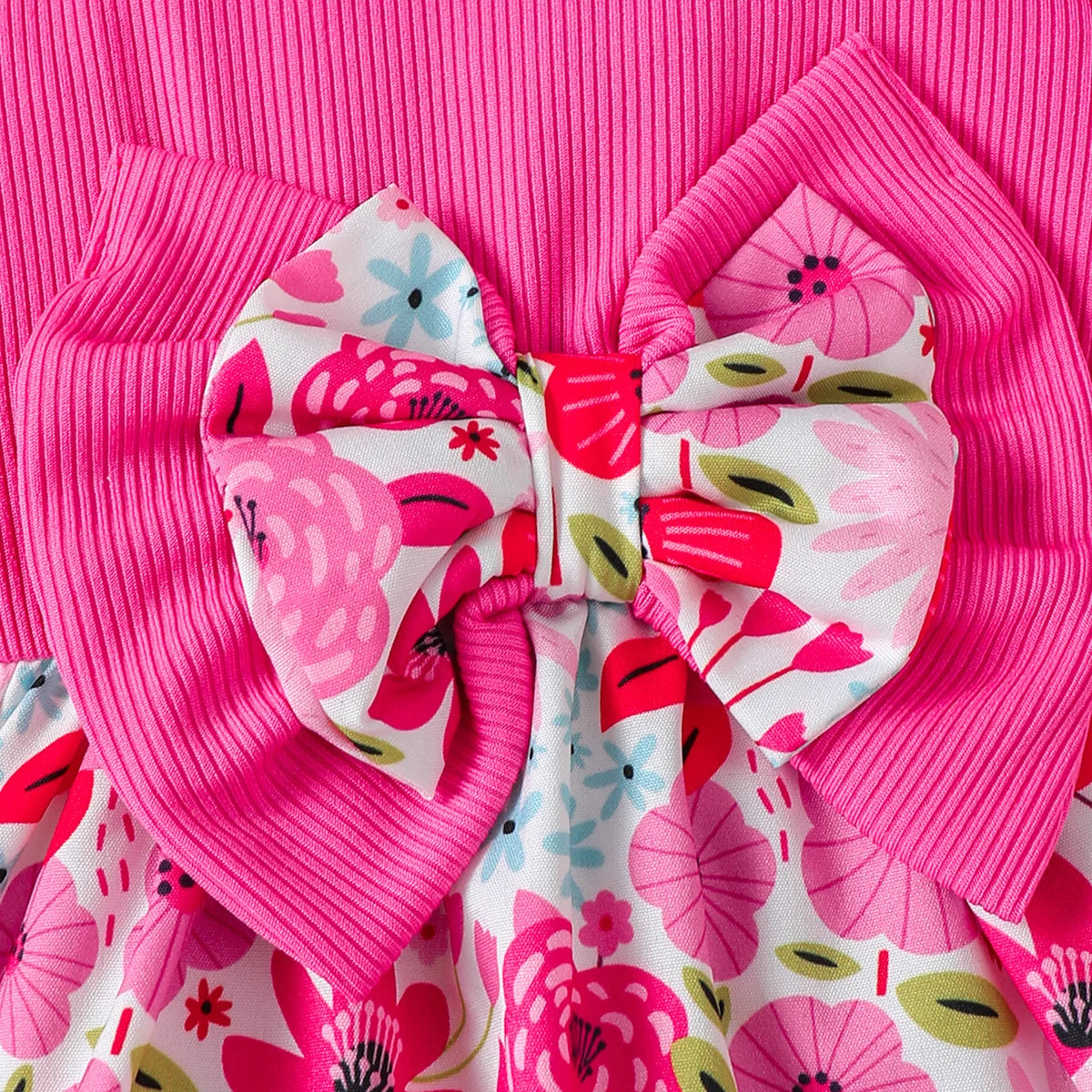 Baby girl wearing a sleeveless floral dress with a bow and matching sun hat