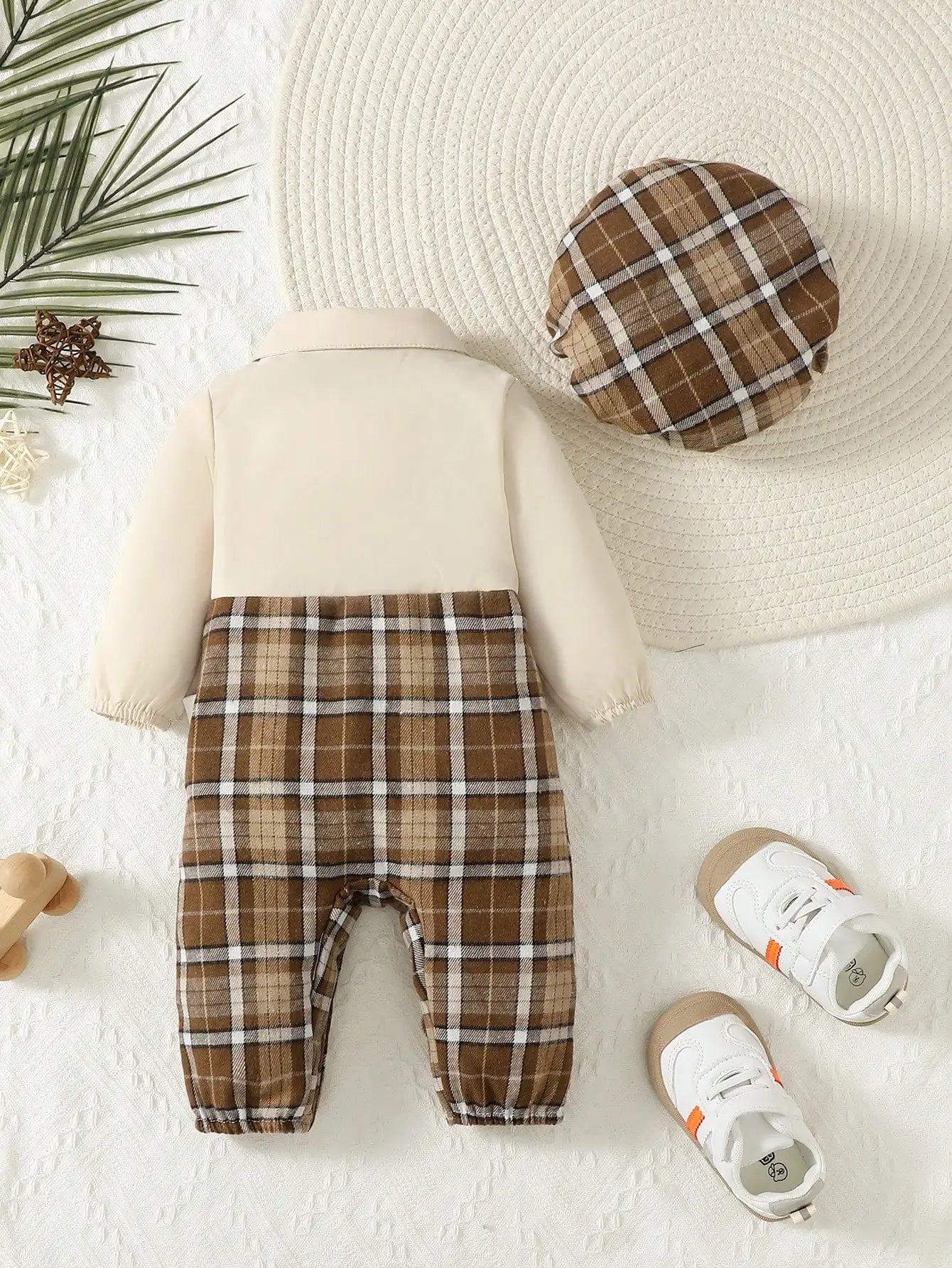 Detail view showing the fabric finish and pattern of the baby boys gentleman jumpsuit with suspenders and hat