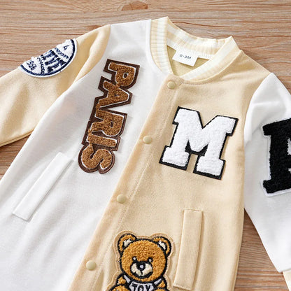 Close up highlighting the hem and stitching on the baby boys cartoon baseball jumpsuit