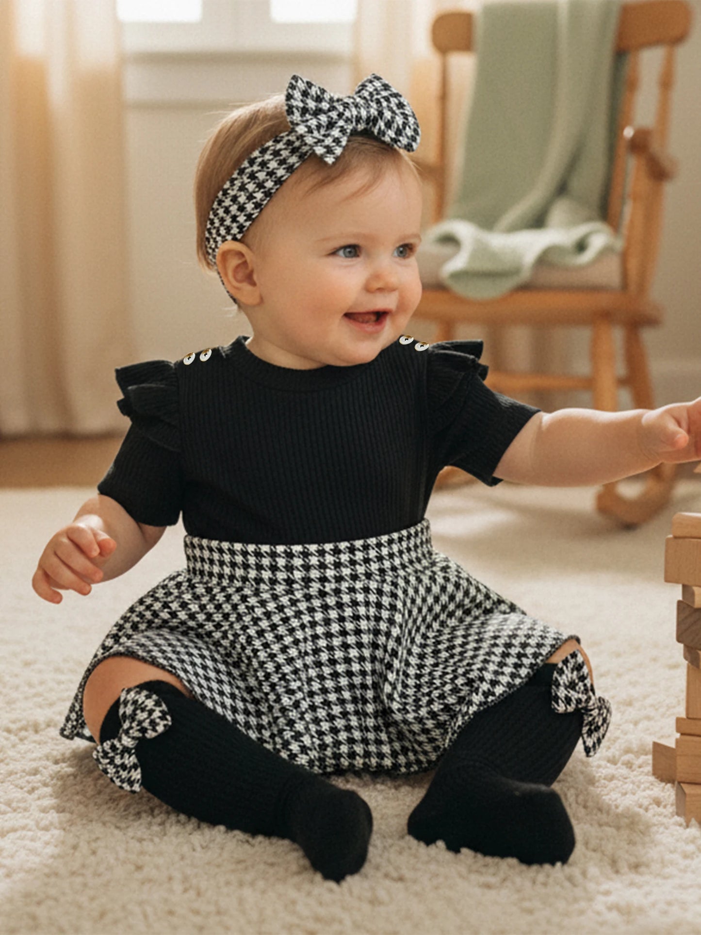 Close up detail of baby girls houndstooth romper dress set