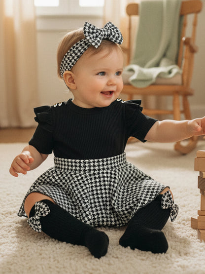 Close up detail of baby girls houndstooth romper dress set