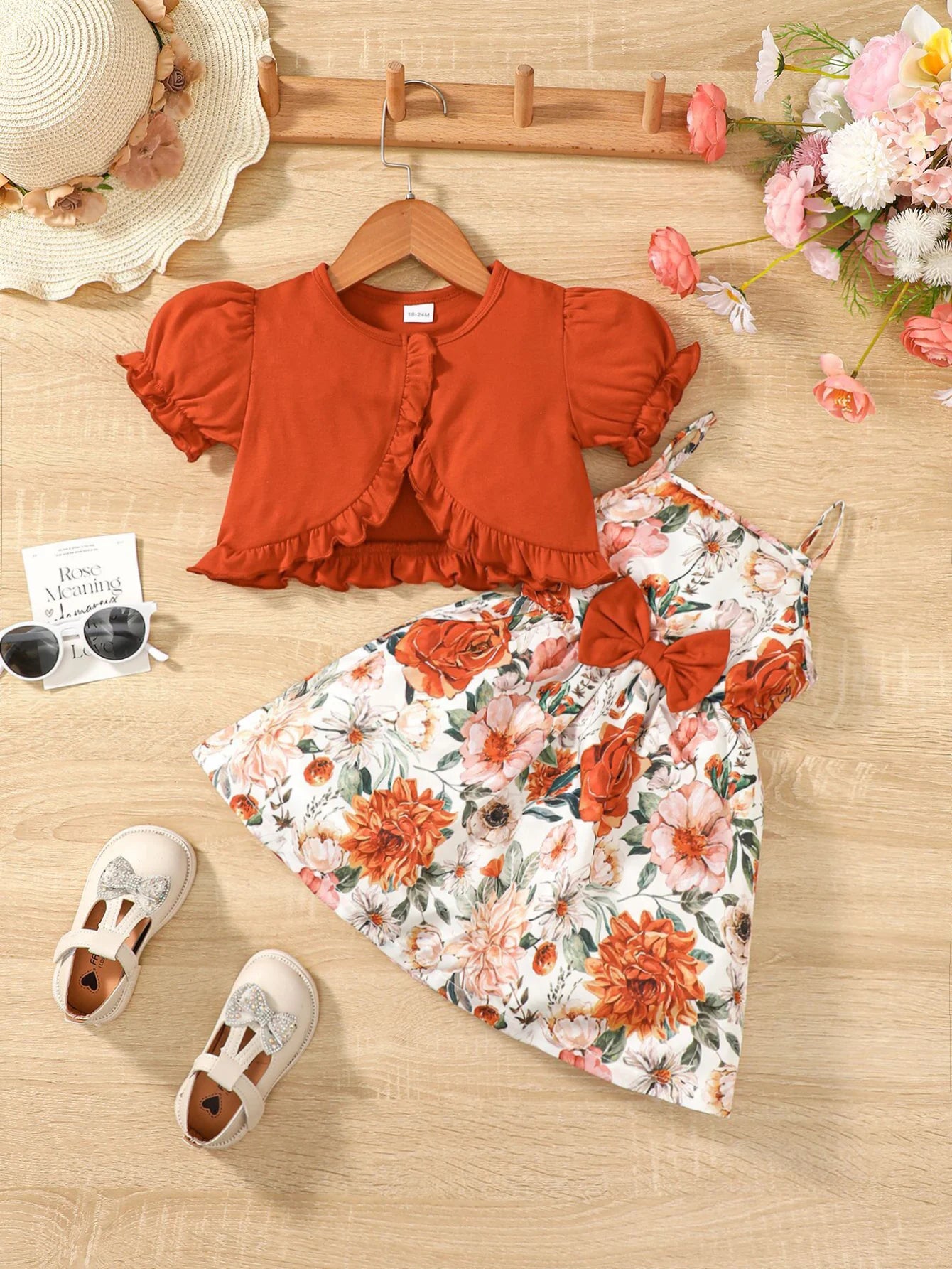 Girl wearing a puff sleeve top and a floral skirt with suspender straps