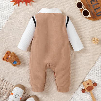 Baby boy wearing a smart short-sleeve romper with an attached tie