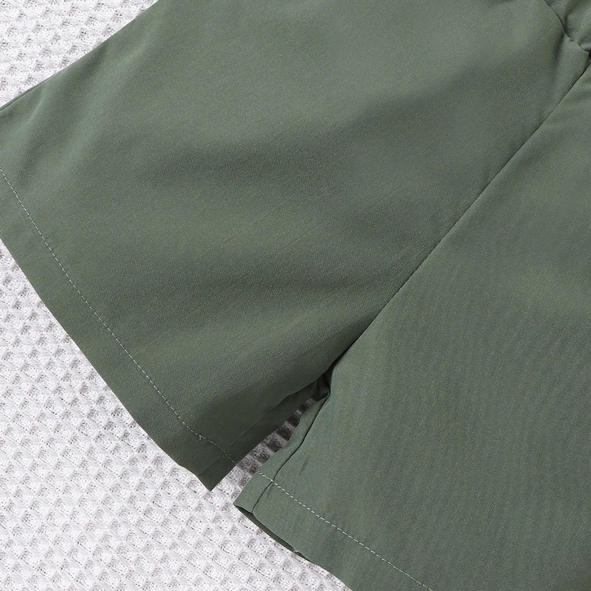 Back or secondary profile shot of the baby boys colour block short sleeve shirt and shorts set