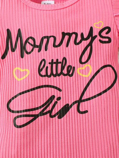Close up highlighting the hem and stitching on the baby girls letter print romper and denim skirt set