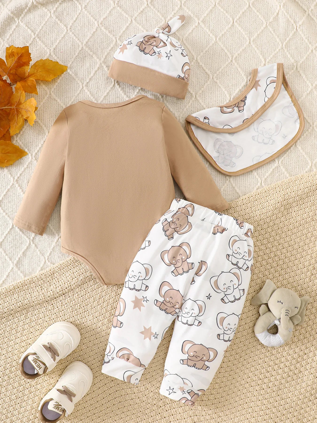 Detail view showing the fabric finish and pattern of the baby boys elephant print romper four-piece set