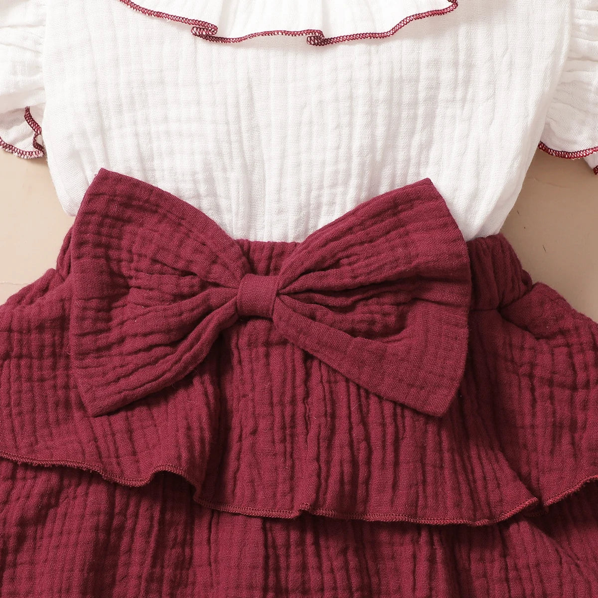 Design features and details on the baby girls red wine layered cupcake dress - view 4