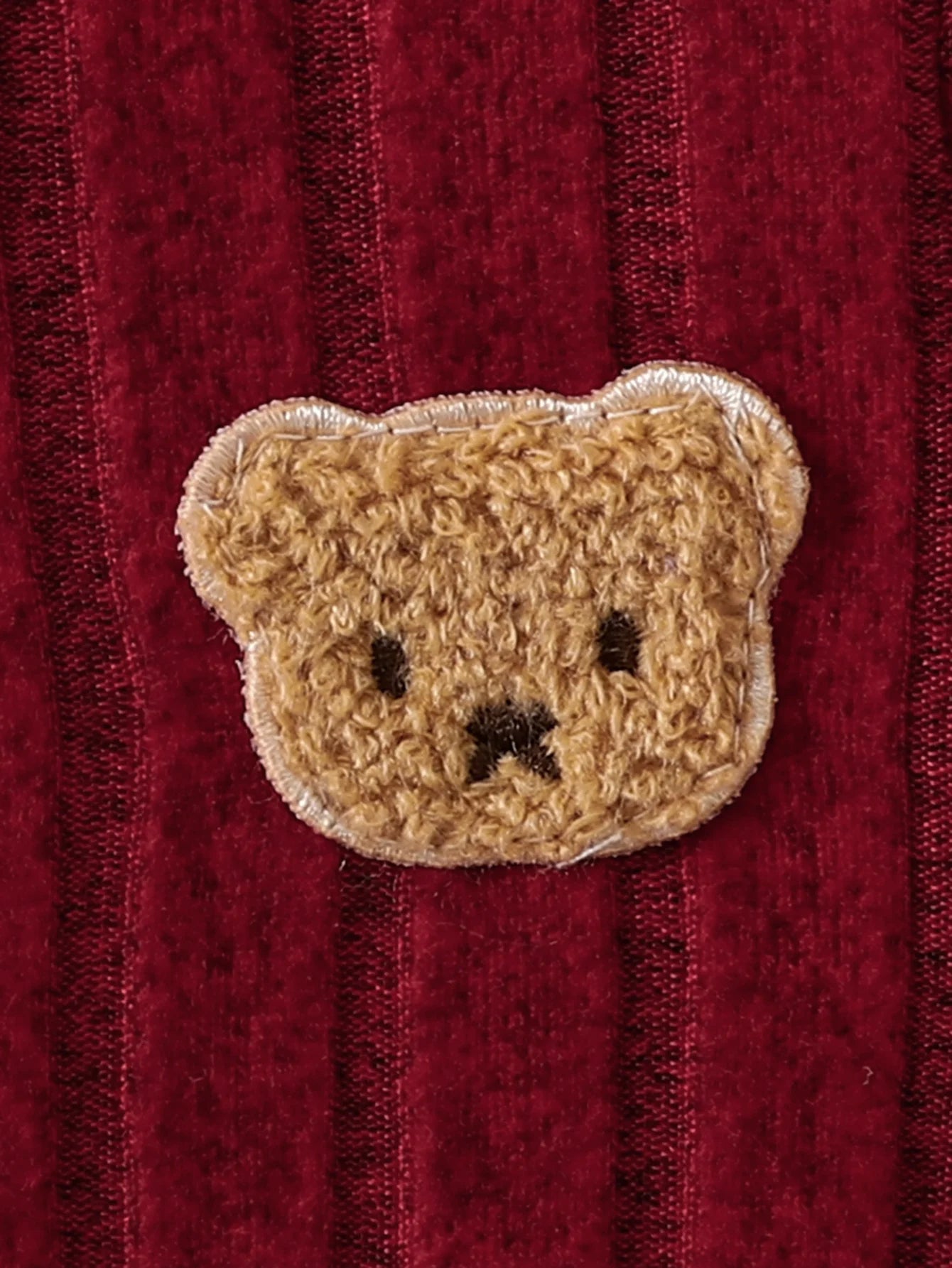 Side view of baby boys red bear badge onesie & hat set