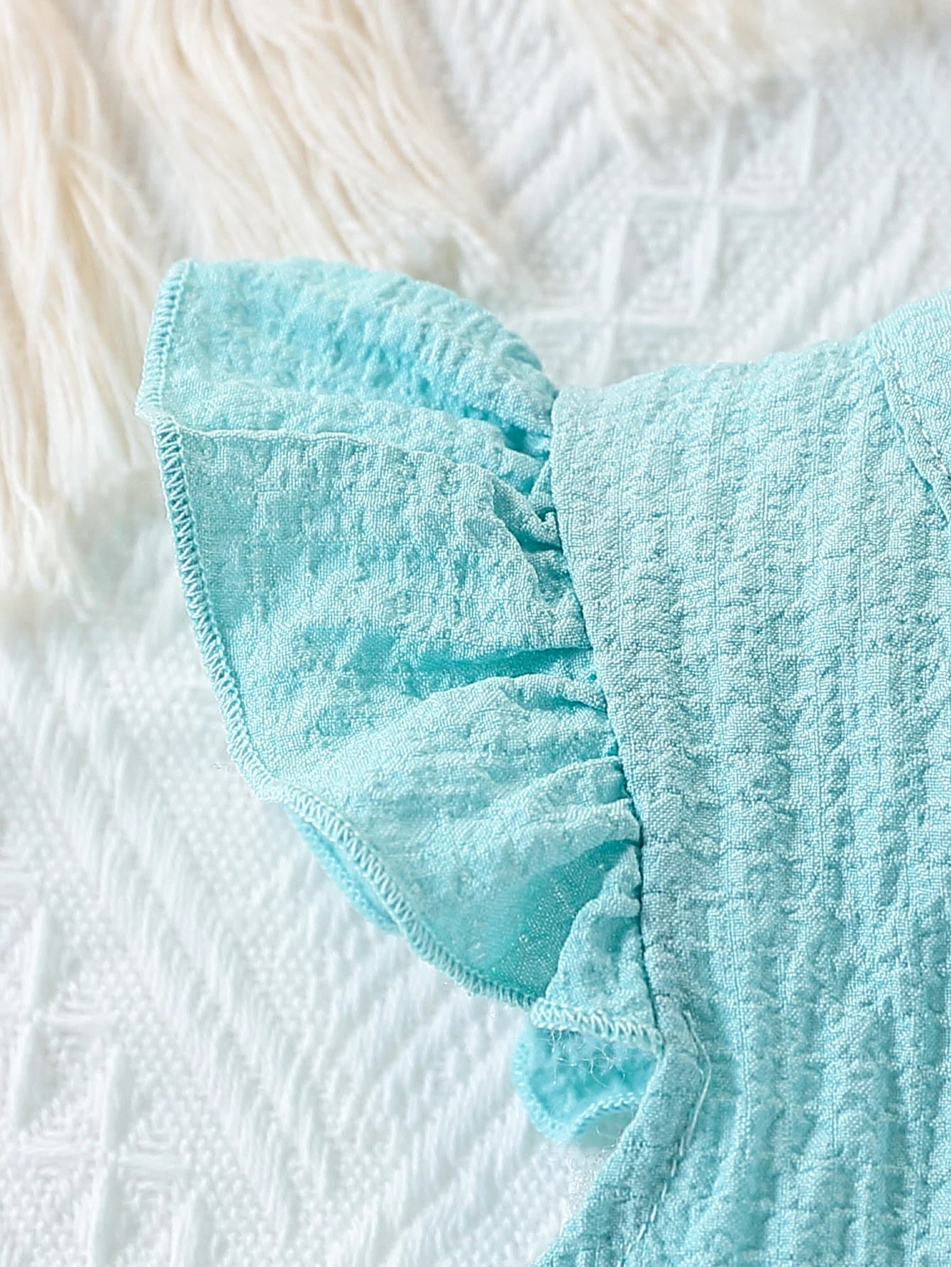 Close up detail of baby girls fly sleeve top & shorts set