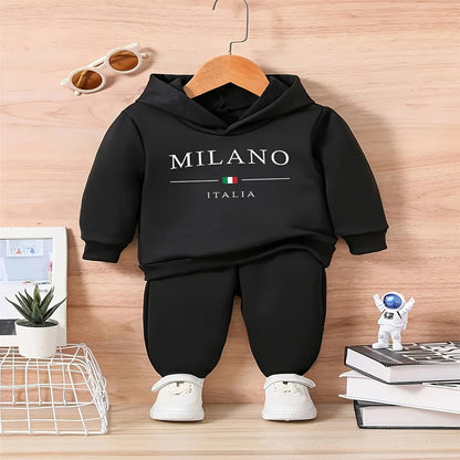 Baby boy wearing a fleece hooded tracksuit with letter print