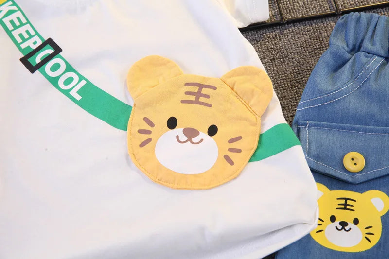 Close up highlighting the hem and stitching on the boys cartoon bear t-shirt and shorts set