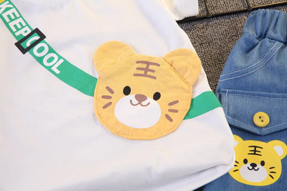 Close up highlighting the hem and stitching on the boys cartoon bear t-shirt and shorts set