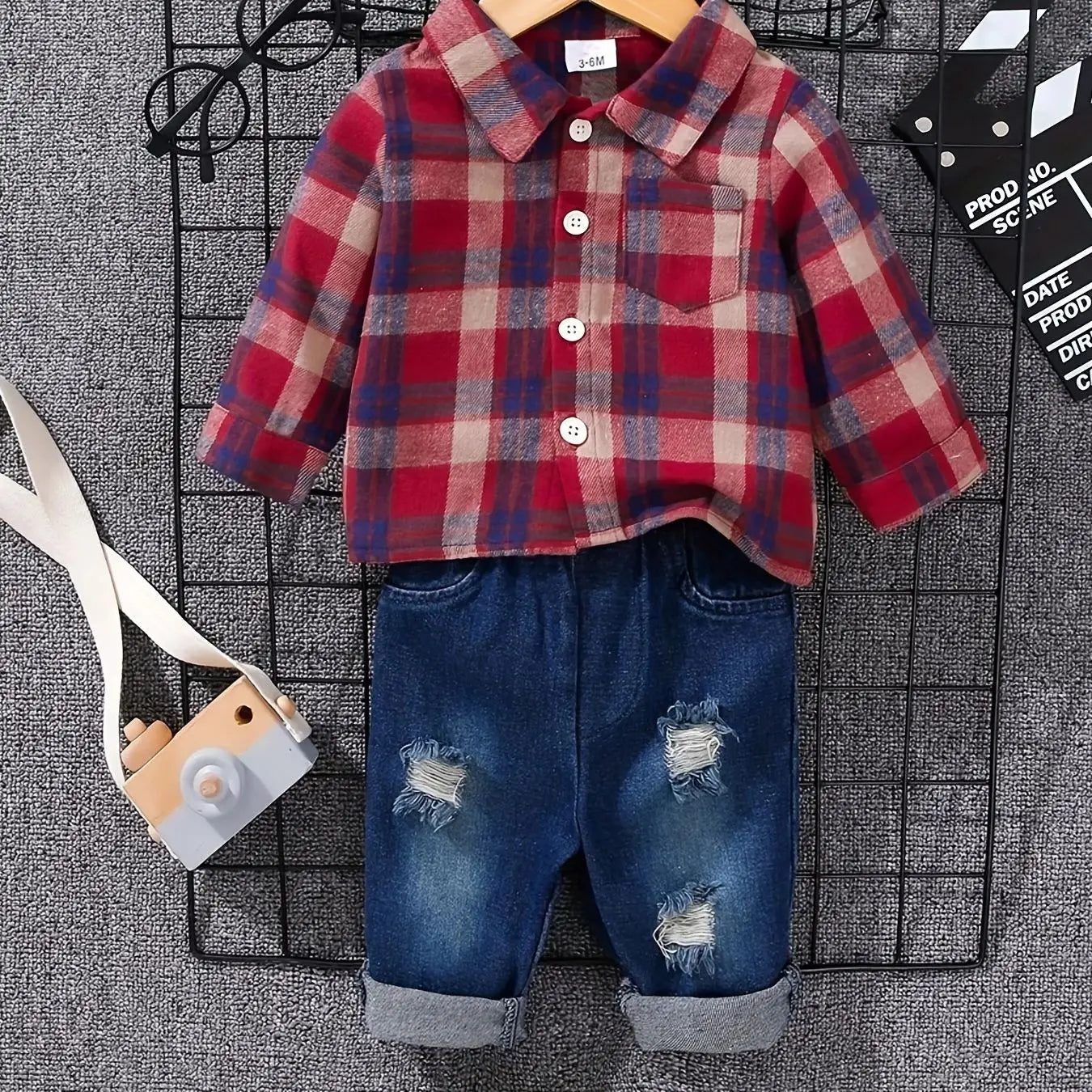 Fabric and texture detail of boys tartan polo shirt & denim trousers set