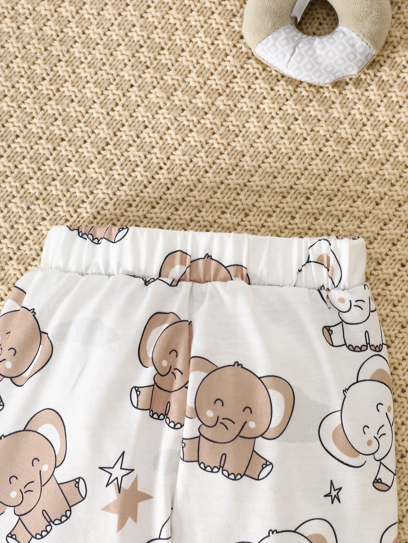 Back or secondary profile shot of the baby boys elephant print romper four-piece set