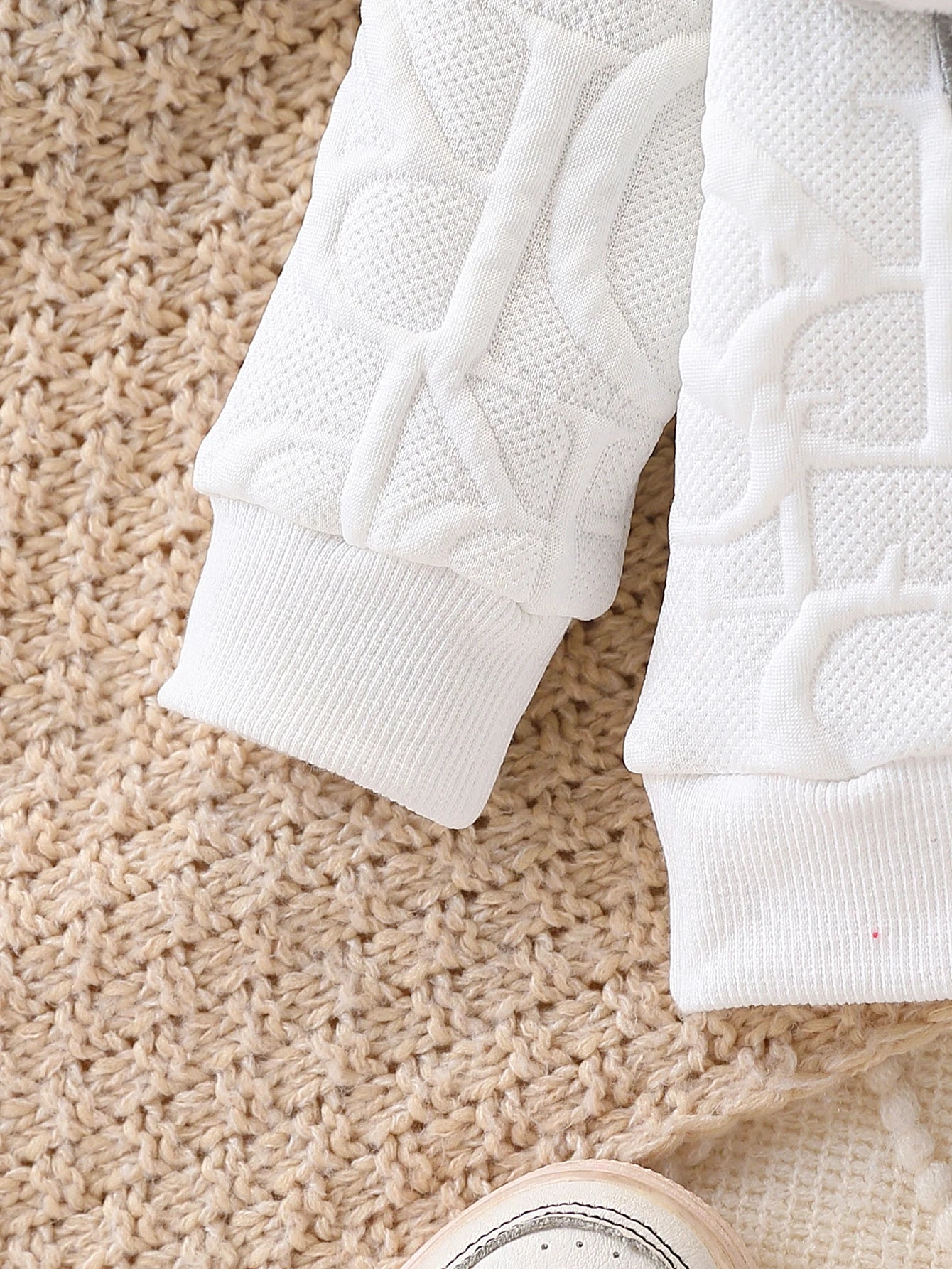 Side or lifestyle view of baby elephant appliqué quilted sweatshirt and joggers set