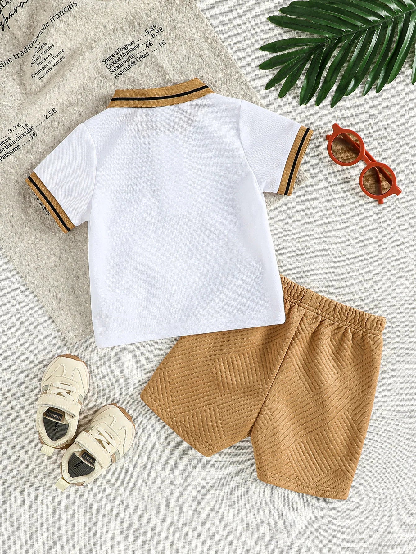 Detail view showing the fabric finish and pattern of the baby boys cartoon t-shirt and shorts summer set