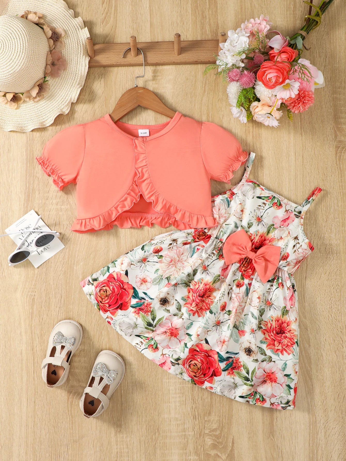 Girl wearing a puff sleeve top and a floral skirt with suspender straps