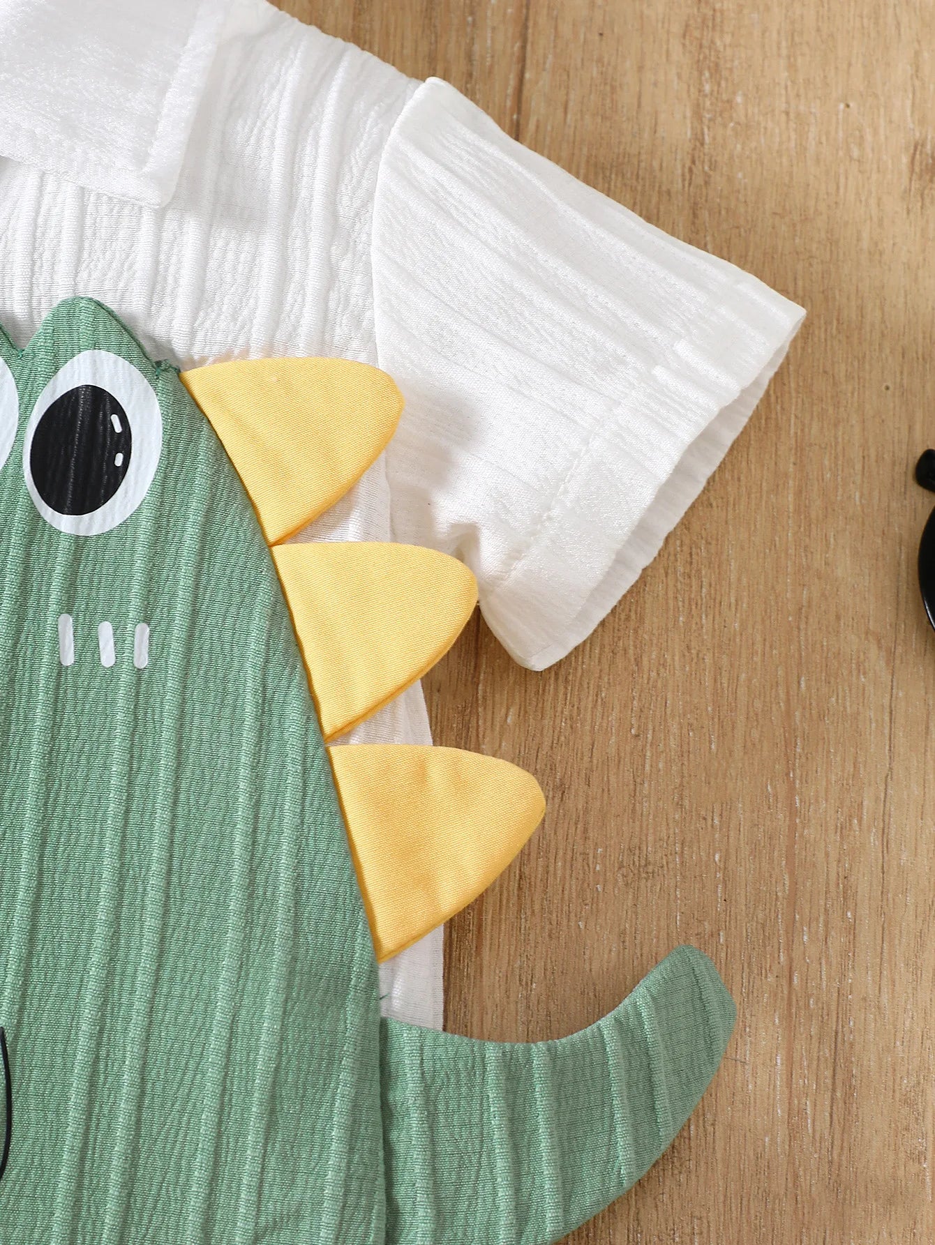 Fabric and texture detail of baby boys dinosaur summer outfit & sun hat