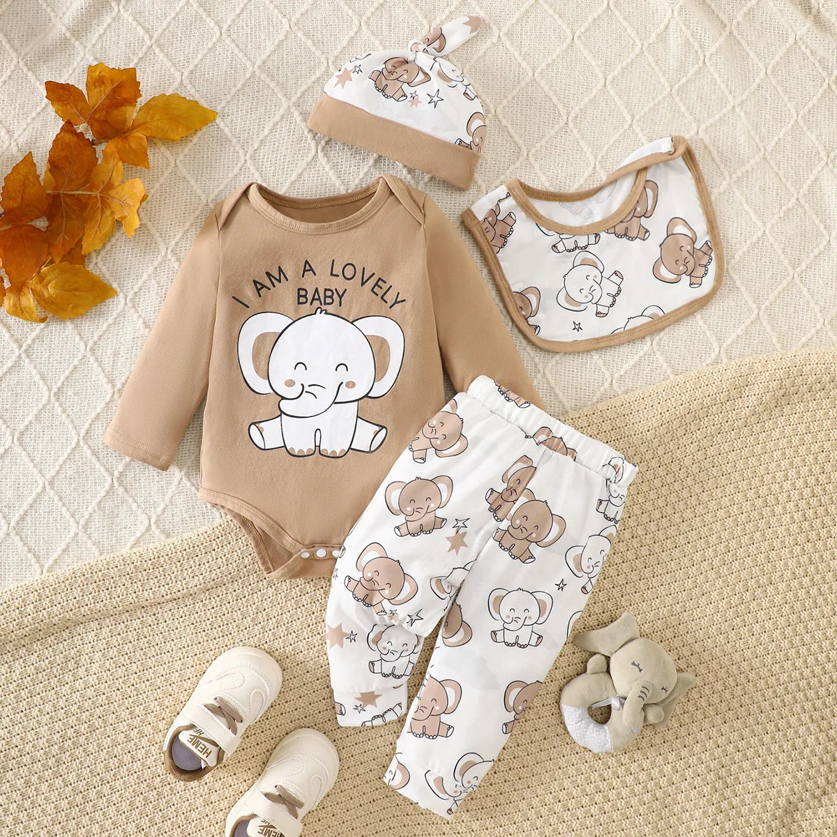 Four piece elephant print baby romper set including bodysuit, trousers, hat and bib