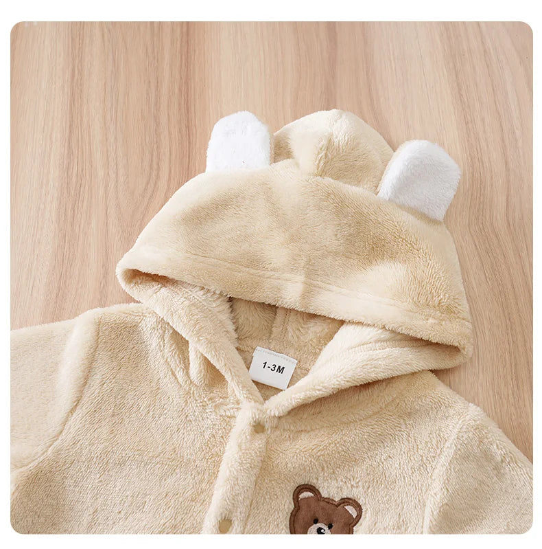 Close up detail of baby bear hooded winter flannel romper