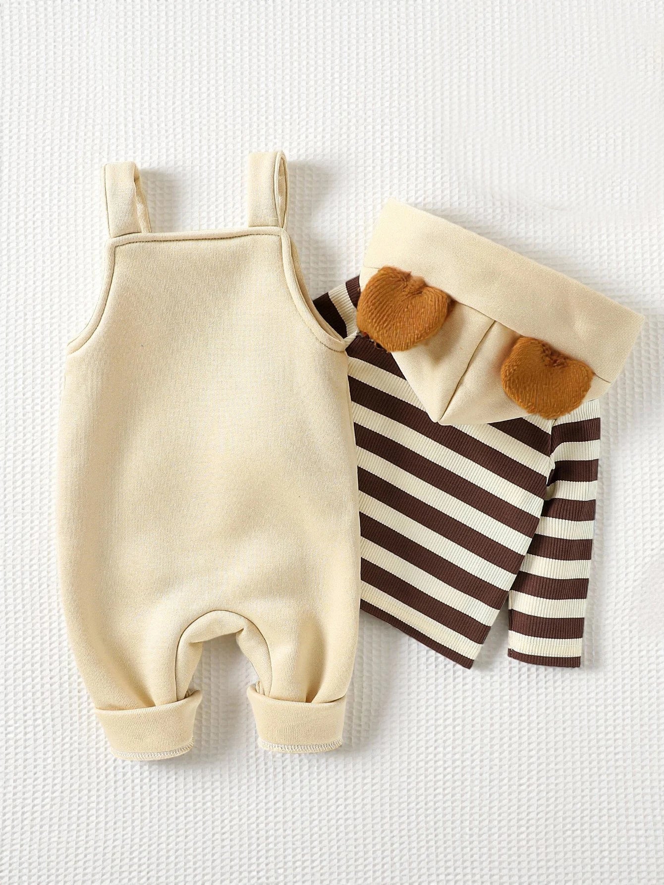 Side view of boys striped hoodie & bear overalls set