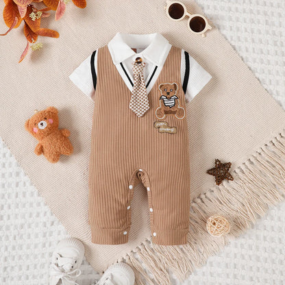 Baby boy wearing a smart short-sleeve romper with an attached tie