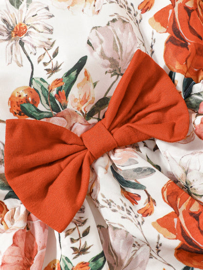 Girl wearing a puff sleeve top and a floral skirt with suspender straps