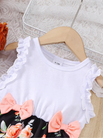 Baby girl wearing a sleeveless floral party dress with a bow